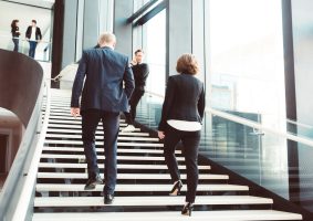 Business professionals walking up stairs