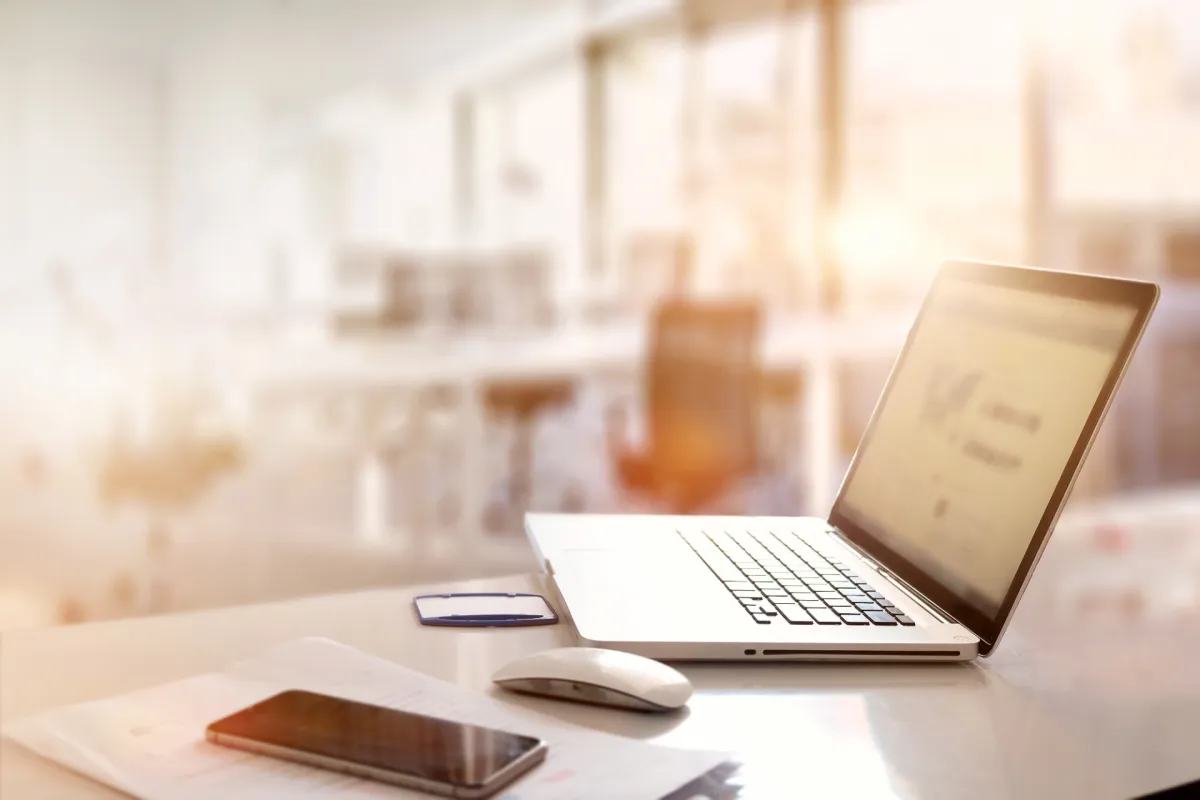 Laptop and paperwork on a desk