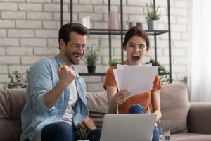 Happy couple cheering their successful new home purchase thanks to Empire Home Loans