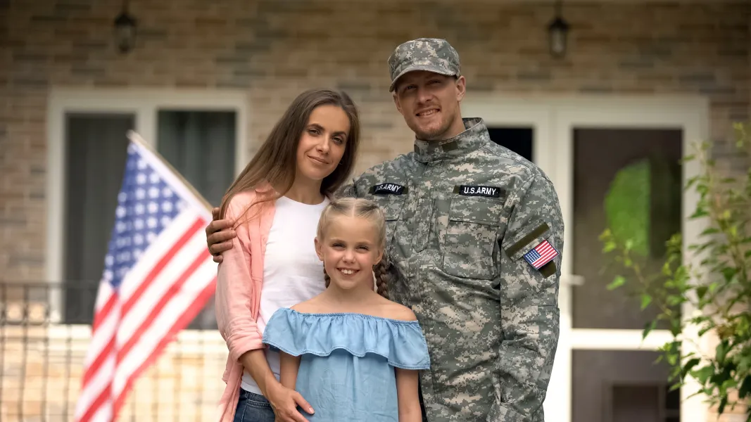 Veteran family in front of home