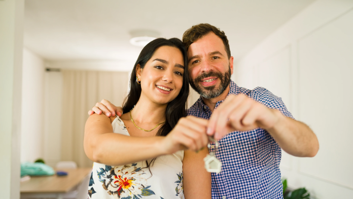 Hispanic couple holding a key
