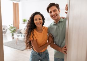 happy couple greeting at the door