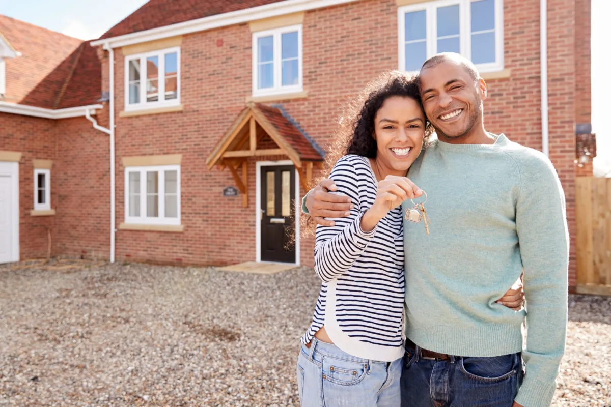 Couple standing outside a home