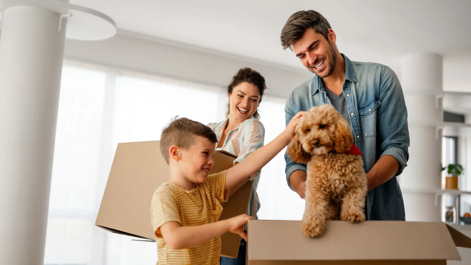 Happy family in front of their new home
