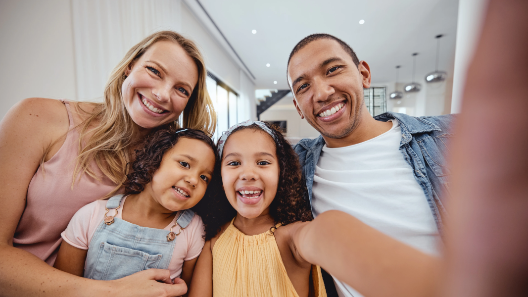 Happy Hispanic family taking a selfie at home