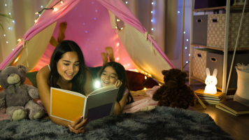 Hispanic mom reading to daughter