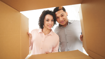 Hispanic couple looking into a box