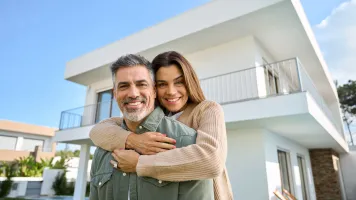 Happy Couple Outside New House