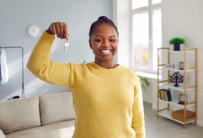 Happy woman holding keys