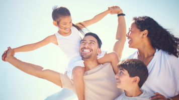 Happy Hispanic family at the beach
