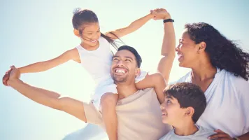 Happy Hispanic family at the beach