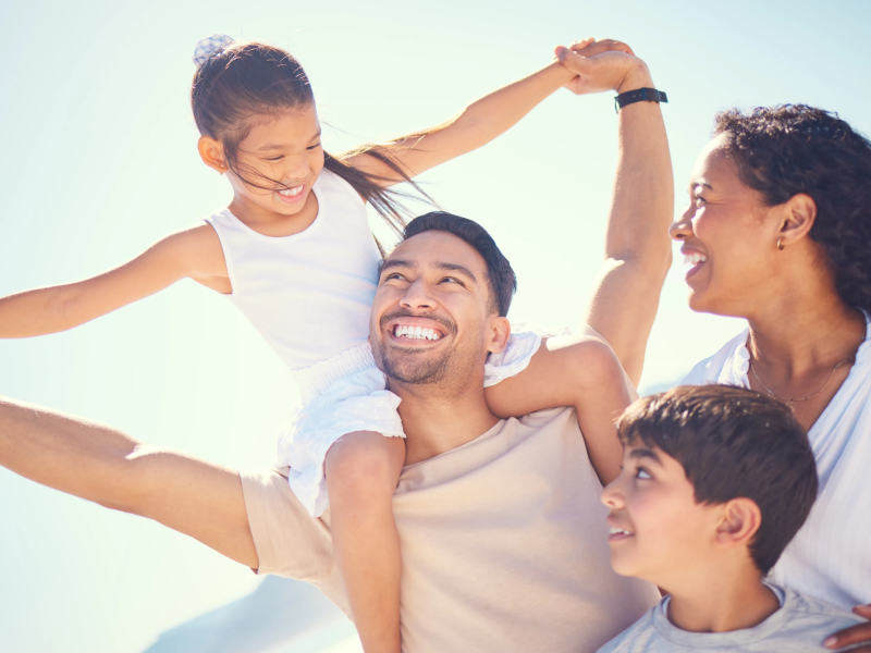 Happy Hispanic family at the beach