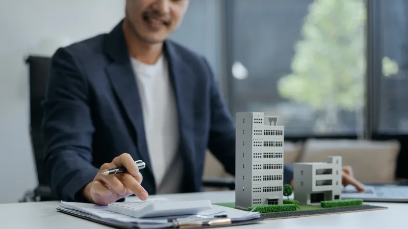 Professional using a calculator at a desk