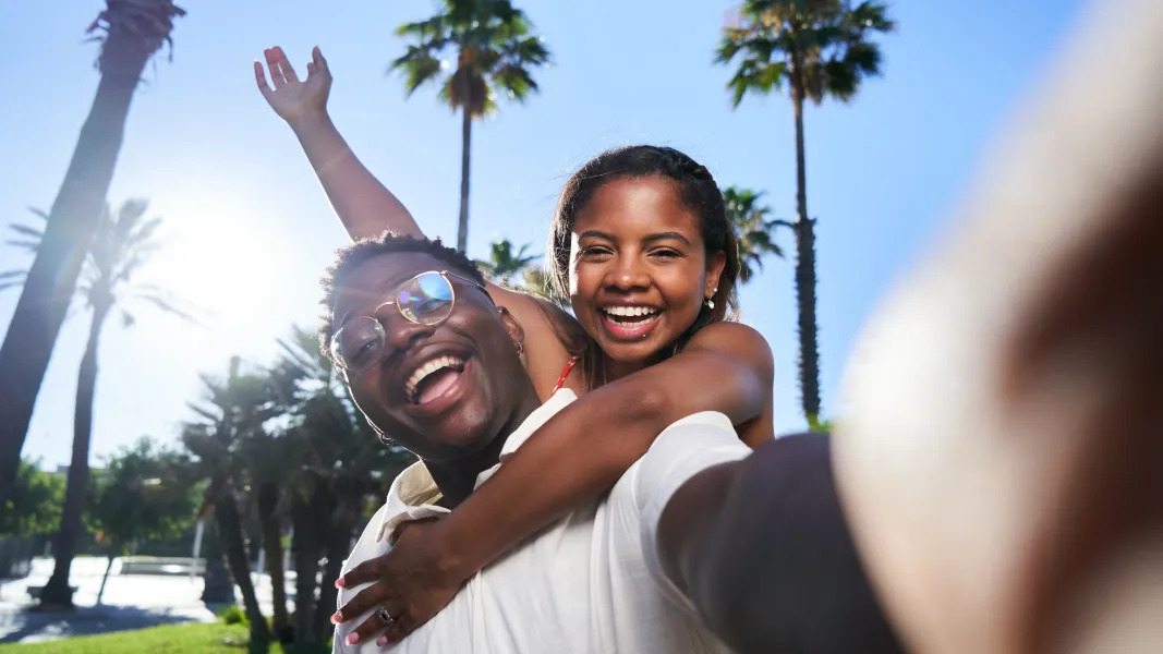 Young black couple at the beach taking a selfie