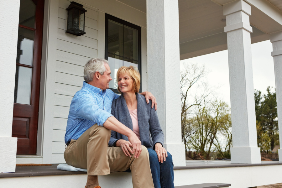 Couple in front of house
