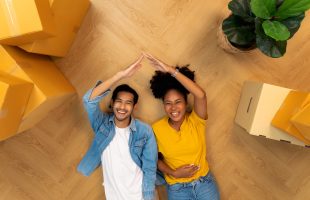 Happy young couple moving into their brand new home