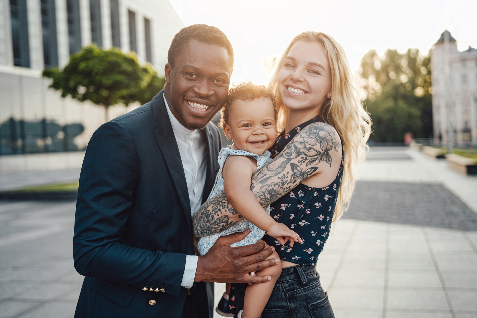 Happy mixed couple, smiling about their new home purchase after they got the right loan
