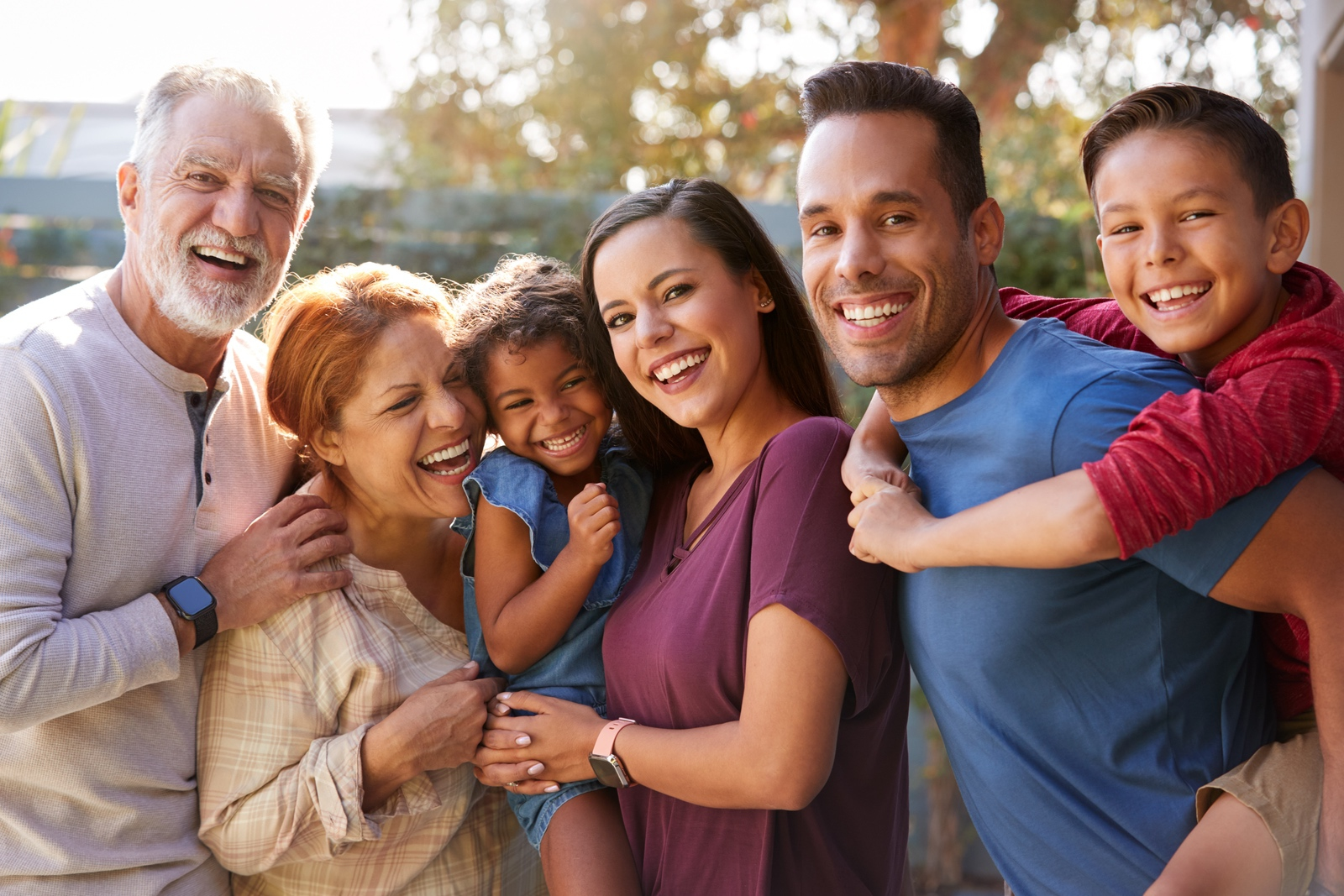 Image of a mixed family, smiling about their new home
