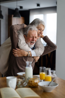 Happy elderly couple in their home they get to keep
