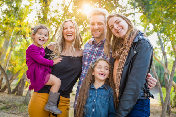 Image of a mixed family, smiling about their new home